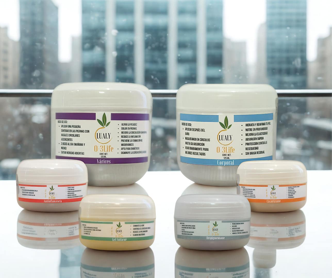 Vista completa de la línea de productos dermatológicos con ozono Lualy O-3Life, incluyendo las cremas para várices, antiinflamatoria, antiacné y corporal, mostrando la variedad de la marca.
